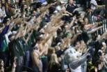 Students showing 'spirit fingers' to cheer on a BU free throw shooter